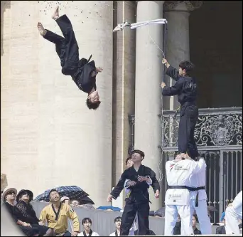  ??  ?? Athletes of the South Korean taekwondo team perform during Pope Francis’ weekly general audience in St. Peter’s Square on Wednesday.