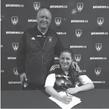  ??  ?? University of Windsor Lancers women’s soccer head coach Steve Hart welcomes striker Sophia Ferrazzo of Vaughn to the team.