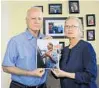  ?? JACOB LANGSTON/STAFF PHOTO ?? Jerry Miller, left, and his sister Christine Rausch hold a photo of their brother Charles Miller.