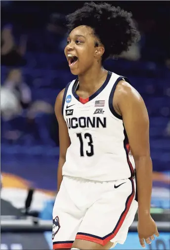  ?? Elsa / Getty Images ?? UConn’s Christyn Williams celebrates her three point shot in the first half against Iowa on Saturday. Williams finished with a game-high 27 points in the 92-72 victory.