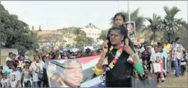  ??  ?? Daniella Moodley, 3, enjoys a rest on the shoulders of her grandmothe­r, Sally Ramsamy, the vice-chairwoman of Ward 73 in Chatsworth, during a march by about 300 people through the township on Sunday. The event was held to honour Nelson Mandela, who would have turned 99 on July 18, as well as promote social cohesion.PICTURE: CHANELLE LUTCHMAN