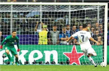  ??  ?? Ronaldo scores the winning penalty Photo: AP