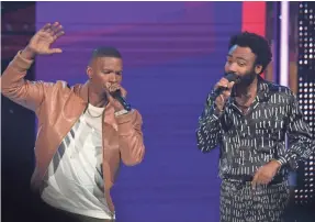  ?? VALERIE MACON/AFP/GETTY IMAGES ?? Donald Glover, right, found himself onstage with Foxx and singing lines from “This Is America” – apparently to his surprise.