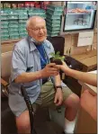  ?? SUBMITTED PHOTO ?? A Peter Becker Community resident receives a plant from the Souderton Area High School SAVE club’s Flower Power program. The plants are grown by students in the school’s greenhouse.