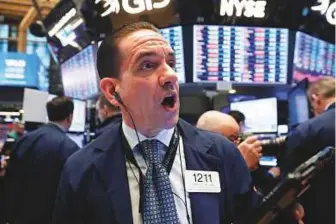  ?? Reuters ?? Traders at the NewYork Stock Exchange are stunned as the market plunged shortly after the opening bell yesterday.