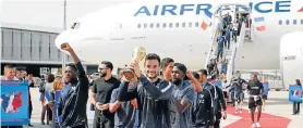  ?? Picture: PASCAL ROSSIGNOL/REUTERS ?? TRIUMPHANT RETURN: The France team return home to the Charles de Gaulle Airport in Paris. Hugo Lloris, the captain and goalkeeper, holds the trophy