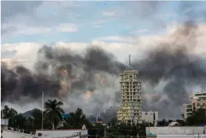  ?? Associated Press ?? ■ Clouds of smoke from burning cars mar the skyline of Culiacan, Mexico. The Mexican city lived under drug cartel terror for 12 hours as gang members forced the government to free a drug lord.