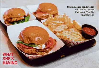  ?? ?? Fried chicken sandwiches and waffle fries at Chicken & The Pig in Lynnfield.