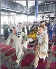  ??  ?? Men carry the coffin carrying a victim in a Shiite mosque attack on Aug 26 in Kabul, Afghanista­n. Dozens of people, including women and children, were killed in an attack on a Shiite mosque in the Afghan capital during
Friday prayers. (AP)