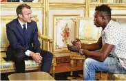  ?? AFP Contributo­r#AFP / ?? Mamoudou Gassama, from Mali, speaking with French President Emmanuel Macron, will have his residency papers expedited because of his heroism.