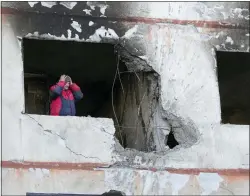  ?? ?? A man holds his head as he stands in his apartment in a multi-story house that was destroyed following a Russian attack in Kharkiv, Ukraine, Thursday, March 24, 2022.