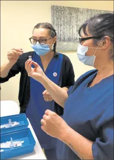  ??  ?? New Dover Road practice nurses Sally-ann Williams and Terri Starmer mixing the Pfizer vaccine