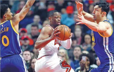  ?? AP FILE ?? Chicago Bulls guard Dwyane Wade snares a pass between a pair of Golden State Warriors during a game in Chicago in March. The 35-year-old is poised to leave the Bulls after reaching an agreement on a buyout.