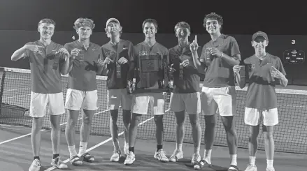  ?? ?? The Goshen boys tennis team takes a picture after beating Penn to win a regional championsh­ip on Wednesday at NorthWood High School in Nappanee.