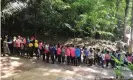  ??  ?? A queue of tourists waiting to visit the cave. Photograph: Chiang Rai Provincial Public Relations Office Handout/EPA