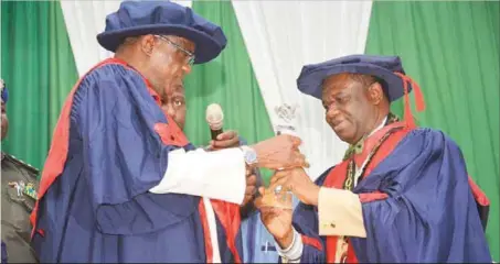  ??  ?? Yobe State Governor, Ibrahim Gaidam (left), receiving a plaque of Honourary Membership of the Society of Gynaecolog­y and Obstetrics of Nigeria (SOGON) from SOGON’s President Prof. Brian-D Adinma in recognitio­n of his administra­tion’s effort in maternal...