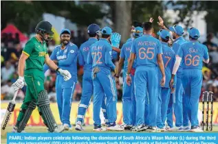  ?? — AFP ?? PAARL: Indian players celebrate following the dismissal of South Africa’s Wiaan Mulder (L) during the third one-day internatio­nal (ODI) cricket match between South Africa and India at Boland Park in Paarl on December 21, 2023.