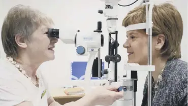  ??  ?? 0 First Minister Nicola Sturgeon has her eyes tested by ophthalmol­ogist Dr Ida Boron, during a visit to the out-patients department of the new East Lothian Community Hospital in Haddington, East Lothian, yesterday