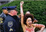  ?? AP ?? A protester is detained as Bill Cosby arrives for his sexual assault trial at the Montgomery County Courthouse on Monday in Norristown, Pa. The protester, Nicolle Rochelle, 39, was charged with disorderly conduct.