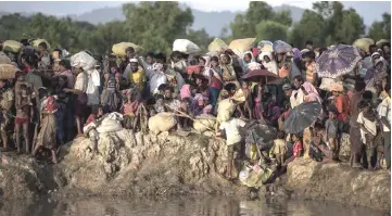  ?? — AFP photo ?? This file photo shows Rohingya refugees, fleeing from Myanmar, arrive at the Naf river in Whaikyang, Bangladesh border.