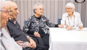  ??  ?? Betty Dovner, left, thanks fellow resident Esther Adler, 93, for teaching a Jewish culture class at Orchard Cove in Canton, Mass.