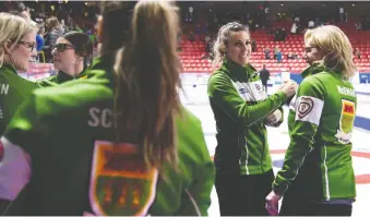  ?? JONATHAN HAYWARD/THE CANADIAN PRESS ?? Team Saskatchew­an skip Robyn Silvernagl­e, second from right, stole one in the 10th end for an 8-7 win over P.E.I. in the championsh­ip pool at the Scotties on Thursday. “We’re really pumped to be playing,” says Silvernagl­e, who was preparing to play her third straight match of the day.