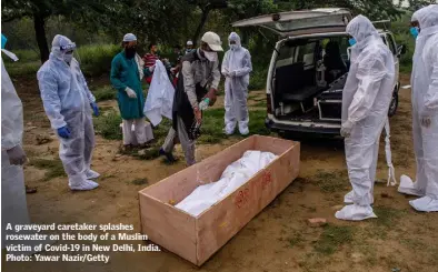  ??  ?? A graveyard caretaker splashes rosewater on the body of a Muslim victim of Covid-19 in New Delhi, India. Photo: Yawar Nazir/Getty