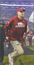  ?? NWA Democrat-Gazette/Ben Goff ?? LEADING THE WAY: Arkansas interim head coach Barry Lunney Jr. leads the team onto the field before last Saturday’s game against LSU at Tiger Stadium in Baton Rouge, La.