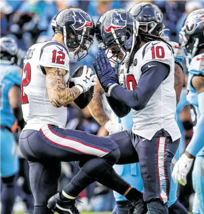  ?? Brett Coomer / Staff photograph­er ?? Kenny Stills (12) and DeAndre Hopkins celebrate Stills’ 16-yard touchdown catch in the second quarter of the Texans’ 24-21 win over the Titans in Sunday’s showdown for the AFC South lead in Nashville, Tenn.