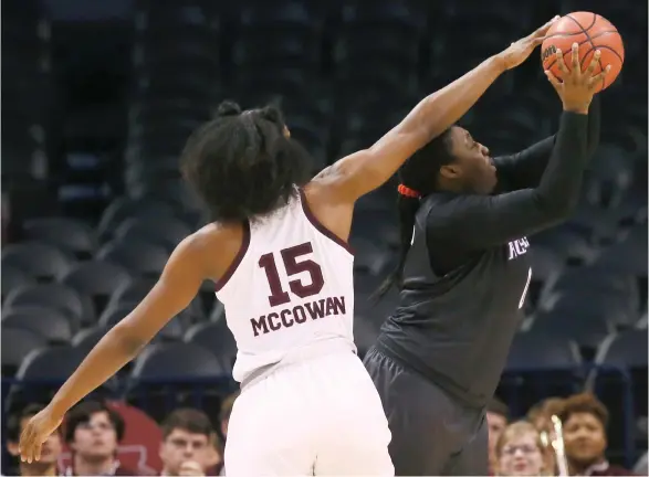  ?? (Photo by Sue Ogrocki, AP) ?? Mississipp­i State center Teaira McCowan (15) blocks a shot by Washington center Chantel Osahor during the first half of Friday’s NCAA Women’s Tournament regional in Oklahoma City.