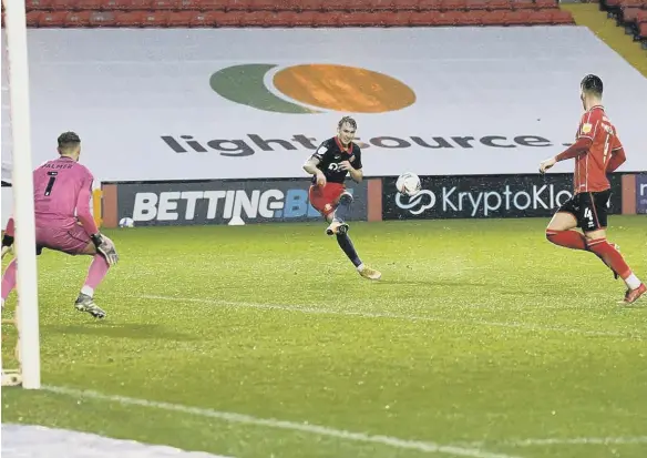  ??  ?? Jack Diamond scores Sunderland’s third at Sincil Bank.