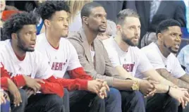  ?? LUIS M. ALVAREZ/AP FILE ?? Miami Heat’s Chris Bosh, center, sits on the bench during a Miami Heat game. Bosh has been seen on the sidelines since his blood clot diagnosis.