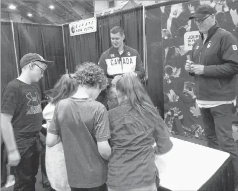  ?? LAURA CHURCHILL DUKE PHOTO ?? Grade 4 students from KCA met two former Olympians at the Milk Fair – Luke Demetre, left, who competed in 2014 at the Sochi Olympics in bobsled, and John Macleod, who competed in waterpolo in the 1976 Montreal Olympics.