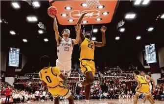  ?? Paul Kuroda / Special to The Chronicle ?? Stanford forward Brandon Angel (23) drives against Cal’s Marsalis Roberson (0) and ND Okafor in the first half of the Cardinal’s victory over the Bears at Maples Pavilion.