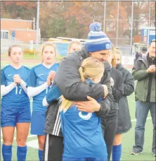  ?? Peter Wallace / For Hearst Connecticu­t Media ?? Lewis Mills coach Jared Sheikh congratula­tes Grace Buchanan after she was named MVP of the Class M state tournament at Ken Strong Stadium in West Haven on Sunday afternoon.