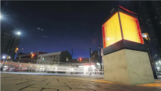  ?? DARREN BROWN/OTTAWA CITIZEN ?? A light box glows warmly on the southeast corner of Waller and Rideau, part of a bumper crop of public art springing up in Ottawa this summer.