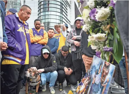  ?? HARRISON HILL/USA TODAY ?? Fans mourn the loss of NBA legend Kobe Bryant on Sunday in Los Angeles outside Staples Center, where the NBA superstar played for 20 years with the Lakers and where the Grammys were held later that day.