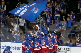  ?? JOHN MUNSON — THE ASSOCIATED PRESS ?? The Rangers and their fans celebrate a shootout victory over the Islanders on April 13in New York.