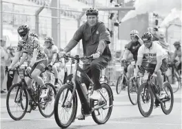  ?? PHOTOS BY SAM NAVARRO Special for the Miami Herald ?? Dan Marino, Miami Dolphins special advisor to the vice chairman, president and CEO, rides his bicycle during the Dolphins Challenge Cancer XIV event on Saturday at Hard Rock Stadium in Miami Gardens.