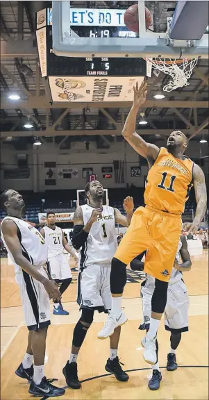  ?? SUBMITTED ?? Tirrell Baines of the Island Storm goes up for layup in front of three members of the Saint John Riptide in Game 4 of the National Basketball League of Canada best-of-five Atlantic Division semifinal series in Charlottet­own on Sunday. Saint John won...