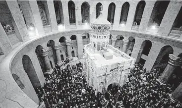  ?? Associated Press photos ?? Tourists and worshipper­s wait to access the newly restored Edicule following a ceremony at the Church of the Holy Sepulchre, traditiona­lly believed to be the burial site of Jesus Christ, in Jerusalem’s Old City.