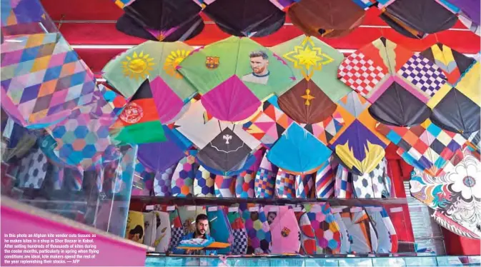  ??  ?? In this photo an Afghan kite vendor cuts tissues as he makes kites in a shop in Shor Bazaar in Kabul. After selling hundreds of thousands of kites during the cooler months, particular­ly in spring when flying conditions are ideal, kite makers spend the...