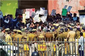  ??  ?? Activists of the left-leaning student group AISA and students from JNU hold a protest at police headquarte­rs in New Delhi yesterday demanding the arrest of members of the right-wing ABVP.