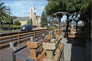  ?? ALAN DEP — MARIN INDEPENDEN­T JOURNAL ?? Benches are stacked on tables outside Restaurant Picco in Larkspur before opening on Thursday. The business pays the city about $600 a month to lease space for its parklet.