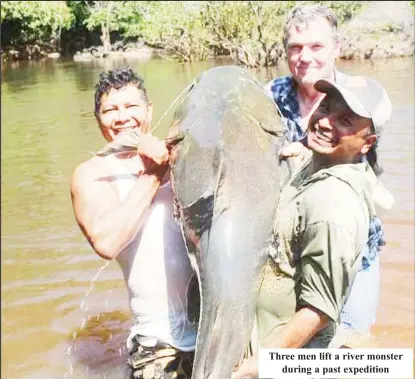  ?? ?? Three men lift a river monster during a past expedition