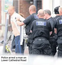  ??  ?? Police arrest a man on Lower Cathedral Road