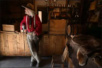  ?? ?? HELEN H. RICHARDSON — THE DENVER POST Historical reenactor and living history volunteer Bill Holcombe, dressed in period clothing, feeds the chickens at Bent’s Old Fort National Historic Site in La Junta on March 10. HELEN H. RICHARDSON — THE DENVER POST Volunteer Bob Kisthart stands in the Native Trade Room at Bent’s Old Fort.