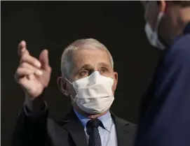  ?? Ap file phOTOs ?? NOT FAKE NEWS: Dr. Anthony Fauci, director of the National Institute of Allergy and Infectious Diseases, speaks with Health and Human Services Secretary Alex Azar before receiving his first dose of the COVID-19 vaccine, left, at the National Institutes of Health on Dec. 22 in Bethesda, Md.