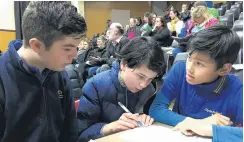  ??  ?? Concentrat­ion . . . Clyde Primary School pupils (from left) Oscar Bartle (13, year 8), Jasmine Anderson (12, year 8) and Taine Morgan (11, year 7) confer during the year 78 quiz.