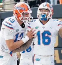  ?? FREDERICK BREEDON/GETTY ?? Quarterbac­k Feleipe Franks (13) and teammate Freddie Swain celebrate after a second-half touchdown that helped to secure UF’s victory at Vanderbilt on Saturday.